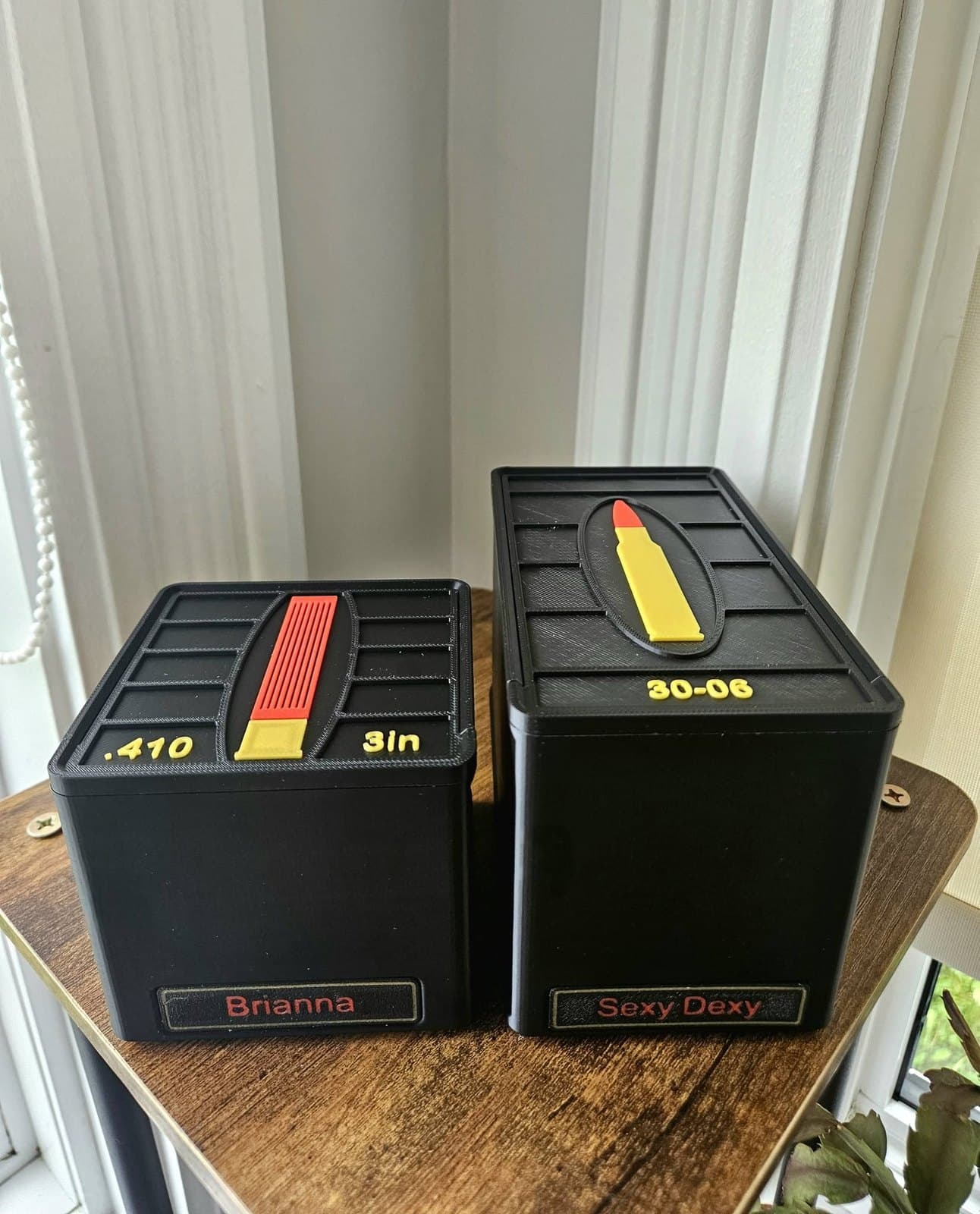 Two personalized black ammunition boxes for .410 and .30-06